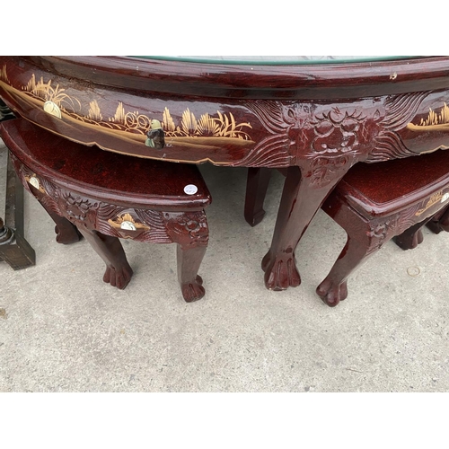 2147 - A CARVED AND DECORATED ORIENTAL STYLE COFFEE TABLE HOUSING A NEST OF SIX MATCHING TABLES