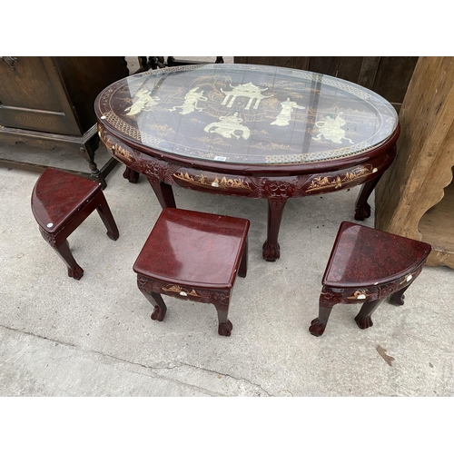 2147 - A CARVED AND DECORATED ORIENTAL STYLE COFFEE TABLE HOUSING A NEST OF SIX MATCHING TABLES