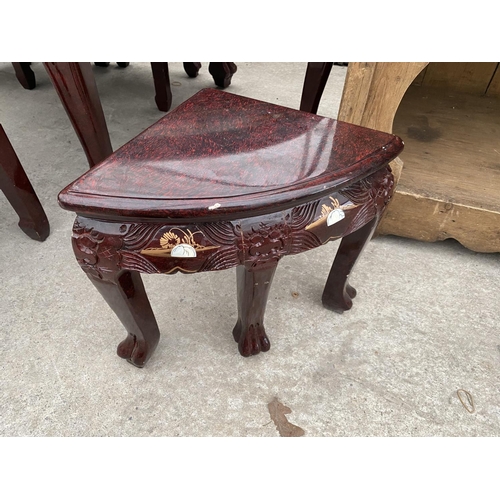 2147 - A CARVED AND DECORATED ORIENTAL STYLE COFFEE TABLE HOUSING A NEST OF SIX MATCHING TABLES