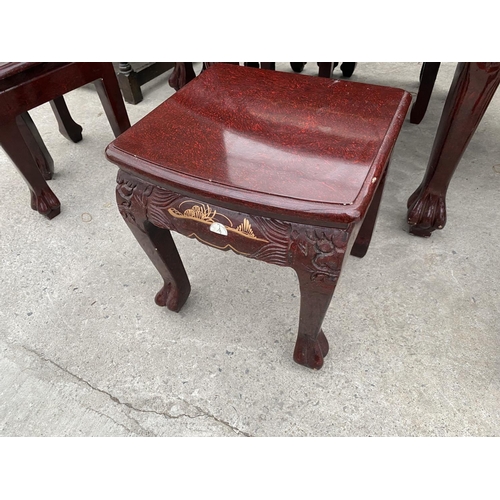 2147 - A CARVED AND DECORATED ORIENTAL STYLE COFFEE TABLE HOUSING A NEST OF SIX MATCHING TABLES