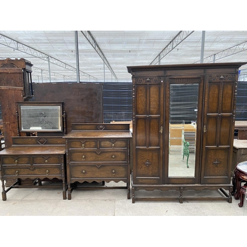 2148 - AN EARLY 20TH CENTURY JACOBEAN STYLE CARVED AND PANELED OAK THREE PIECE BEDROOM SUITE ON TURNED SUPP... 