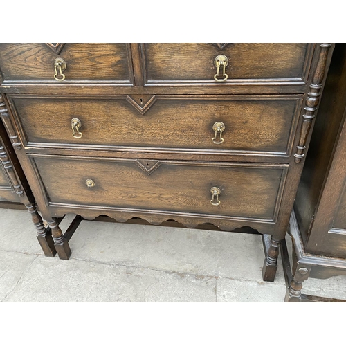 2148 - AN EARLY 20TH CENTURY JACOBEAN STYLE CARVED AND PANELED OAK THREE PIECE BEDROOM SUITE ON TURNED SUPP... 