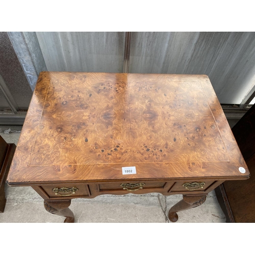 1802 - A REPRODUCTION BURR WALNUT LOW BOY OF THREE DRAWERS ON CABRIOLE LEGS, 27