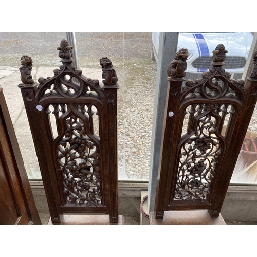 1805 - A PAIR OF VICTORIAN OAK GOTHIC STYLE HALLCHAIRS WITH CARVED FRETWORK FOLIATE BACKS, ON TURNED FRONT ... 