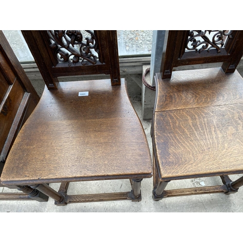 1805 - A PAIR OF VICTORIAN OAK GOTHIC STYLE HALLCHAIRS WITH CARVED FRETWORK FOLIATE BACKS, ON TURNED FRONT ... 