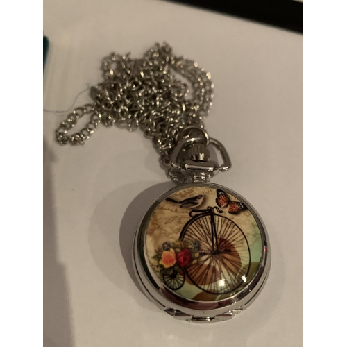 515 - A BOXED WHITE METAL POCKET WATCH WITH AN ENAMEL PENNY FARTHING DECORATION AND CHAIN