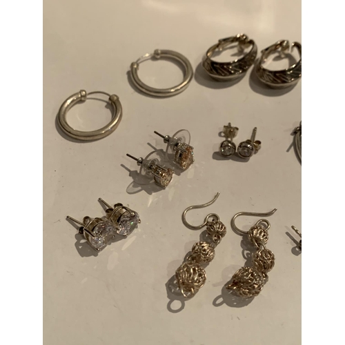 550 - TWELVE PAIRS OF SILVER EARRINGS TO INCLUDE DROPS, STUDS, RINGS ETC