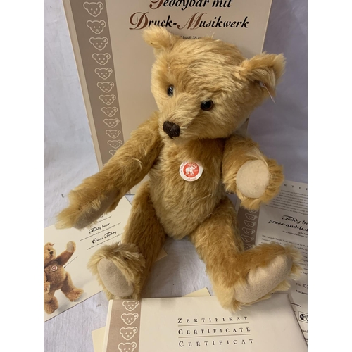 330 - A STEIFF TEDDY BEAR WITH A PRESS AND LISTEN MUSIC BOX WITH BOX AND CERTIFICATE