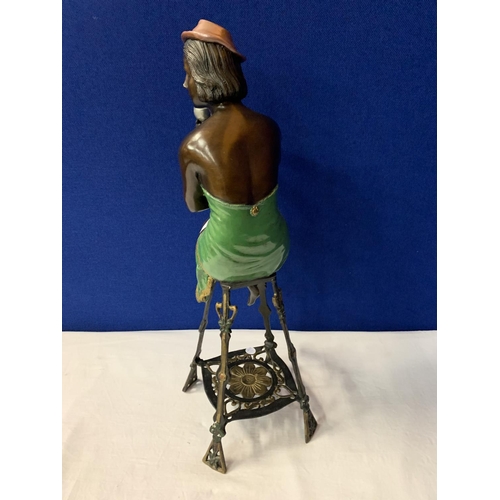 1 - A BRONZE FIGURINE OF A SEMI-NUDE POSED ON A TALL STOOL IN AN ART DECO STYLE