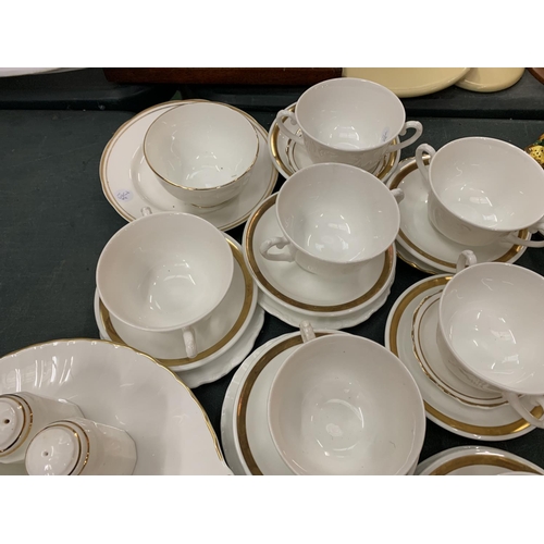 100 - AN ASSORTMENT OF WHITE DINNER WARE WITH GOLD DETAIL