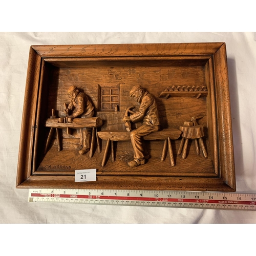 21 - A SIGNED WOODEN CARVED PICTURE DEPICTING CARPENTERS AT WORK