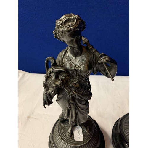 28 - A PAIR OF SPELTER FIGURINES ON POLISHED WOODEN BASES