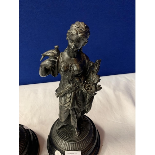 28 - A PAIR OF SPELTER FIGURINES ON POLISHED WOODEN BASES