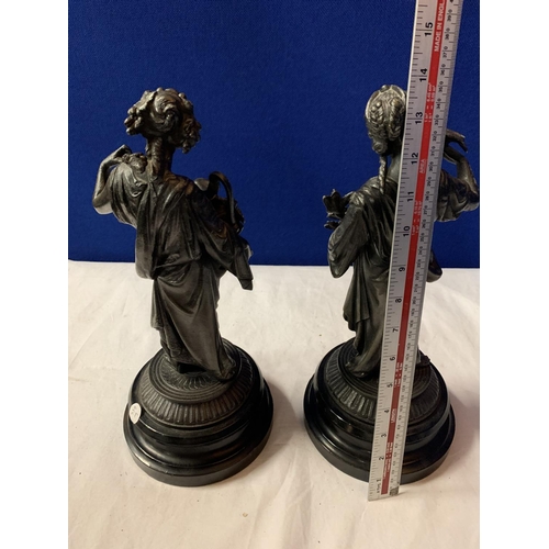 28 - A PAIR OF SPELTER FIGURINES ON POLISHED WOODEN BASES