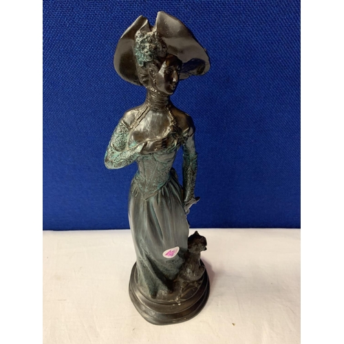 7 - AN SPELTER EDWARDIAN STYLE FIGURINE OF A LADY AND HER DOG