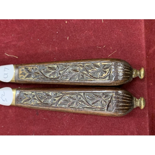 73 - A PAIR OF CARVED WOOD AND BRASS VINTAGE NUT CRACKERS