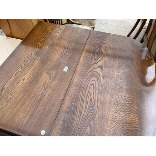 1854 - A MID 20TH CENTURY OAK GATELEG DINING TABLE ON BARLEYTWIST LEGS