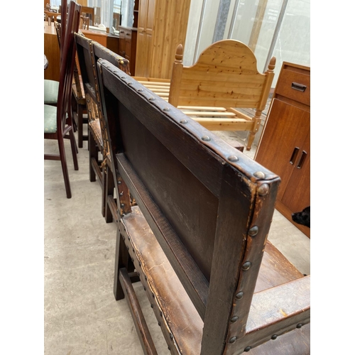 1857 - A SET OF SIX CARVED OAK DINING CHAIRS WITH STUDDED LEATHER SEATS AND BACKS (INCLUDING ONE CARVER)