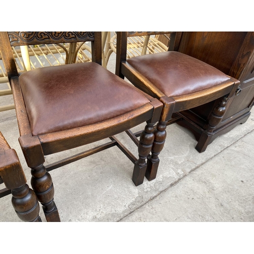 1933 - A SET OF FOUR EARLY 20TH CENTURY OAK DINING CHAIRS WITH LEATHER SEATS AND BACKS WITH STUDDED DECORAT... 