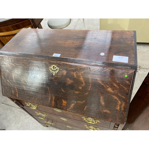 1941 - A GEORGE III STYLE OAK BUREAU WITH FITTED INTERIOR AND THREE GRADUATED DRAWERS, 30