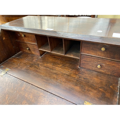 1941 - A GEORGE III STYLE OAK BUREAU WITH FITTED INTERIOR AND THREE GRADUATED DRAWERS, 30