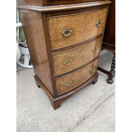 1943 - A REPRODUCTION WALNUT BOWFRONTED CHEST ON CHEST OF SIX GRADUATED DRAWERS, 21