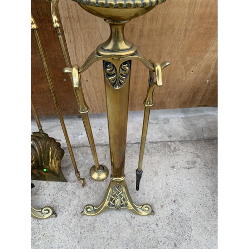 1206 - TWO DECORATIVE BRASS FIRE DOGS WITH A COMPLETE COMPANION SET