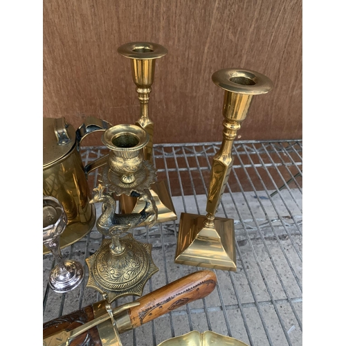 1225 - A LARGE QUANTITY OF BRASS ITEMS TO INCLUDE SEVERAL CANDLE STICK HOLDERS, BRASS KETTLE, AN ORNATE IND... 