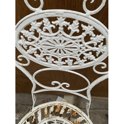 1233 - A PAIR OF ORNATE CAST IRON GARDEN CHAIRS