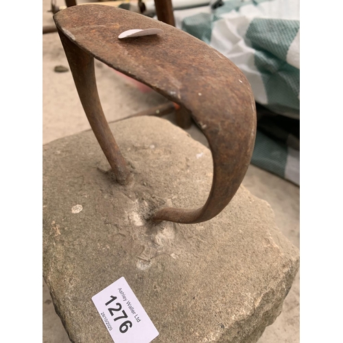 1276 - A VINTAGE CAST IRON BOOT SCRAPER SET ON A HEAVY STONE BASE