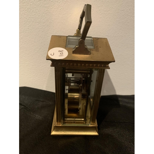 630 - A BRASS CARRIAGE CLOCK WITH  GABLED TOP WITH GLASS VIEWING PANE, FRENCH MECHANICAL MOVEMENT AND KEY