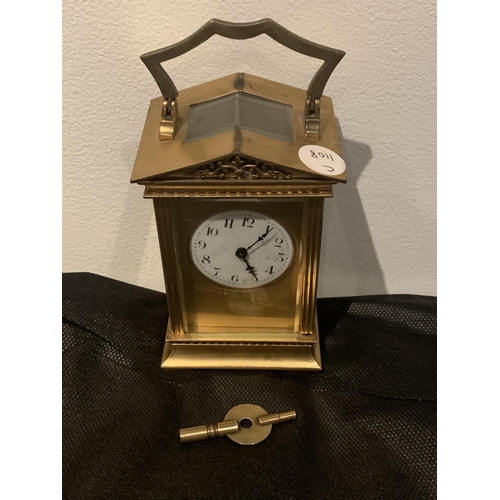 630 - A BRASS CARRIAGE CLOCK WITH  GABLED TOP WITH GLASS VIEWING PANE, FRENCH MECHANICAL MOVEMENT AND KEY