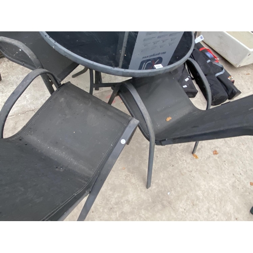 1541 - A METAL GARDEN TABLE WITH BLACK GLASS TOP AND FOUR GARDEN CHAIRS