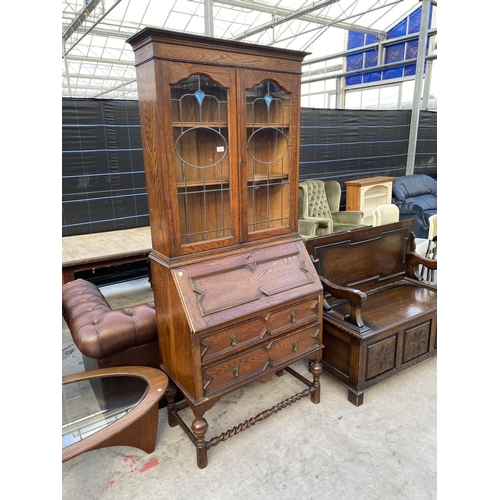 2138 - AN EARLY 20TH CENTURY OAK BUREAU BOOKCASE ON TURNED LEGS, BARLEYTWIST FRONT STRETCHER, HAVING GLAZED... 