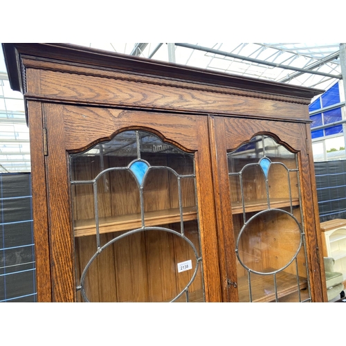 2138 - AN EARLY 20TH CENTURY OAK BUREAU BOOKCASE ON TURNED LEGS, BARLEYTWIST FRONT STRETCHER, HAVING GLAZED... 