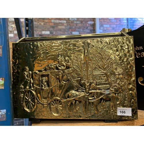 166 - A BRASS MAGAZINE RACK WITH COACHING SCENE DEPICTED