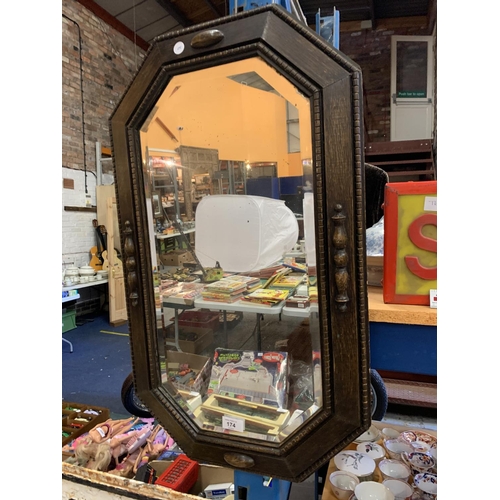 174 - A VICTORIAN OAK EIGHT SIDED BEVELLED MIRROR