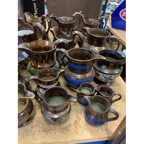 186 - A LARGE QUANTITY OF VARIOUS SIZED LUSTRE WARE JUGS