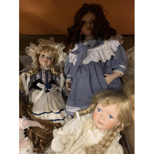 262 - SIX PORCELAIN HEADED DOLLS OF VARIOUS SIZES TO INCLUDE A LARGE DOLL IN A BLUE AND WHITE DRESS AND A ... 