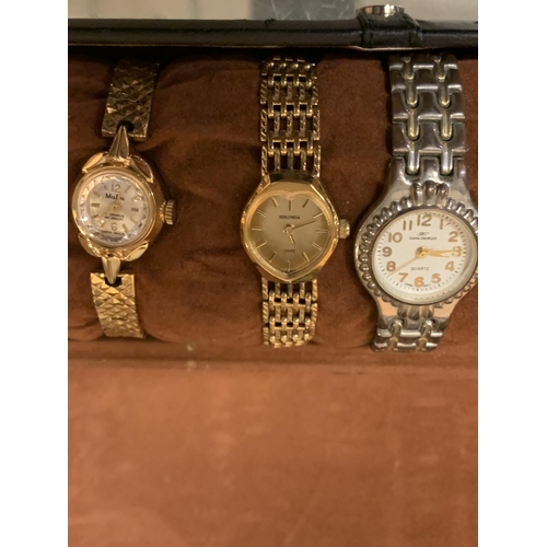 651 - SIX METAL LADIES WATCHES AND TWO BRACELETS TO INCLUDE A BLACK CYLINDRICAL PRESENTATION CASE