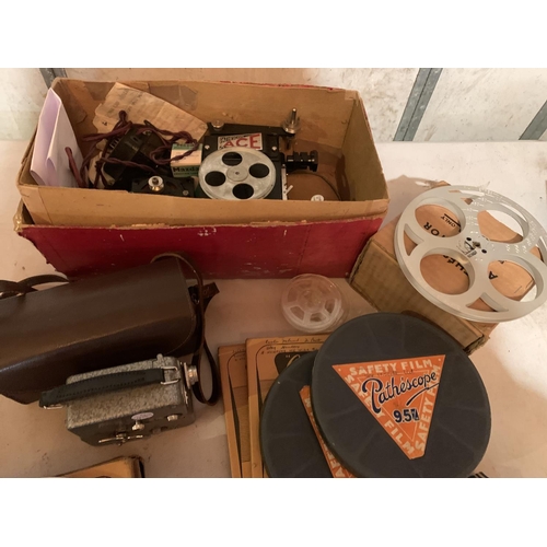 867 - A PATHESCOPE ACE CAMERA ALONG WITH SEVERAL REELS OF FILM AND FILM MENDER