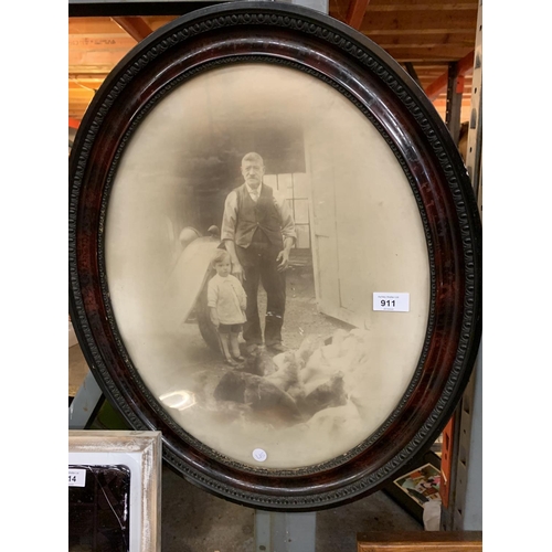 911 - A LARGE WOODEN FRAMED OVAL MIRROR AND OVAL PORTRAIT VINTAGE PHOTOGRAPH OF MAN WITH GIRL AND HENS