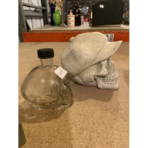 929 - A PEAKY BLINDERS STYLE STONE SKULL AND A GLASS SKULL BOTTLE