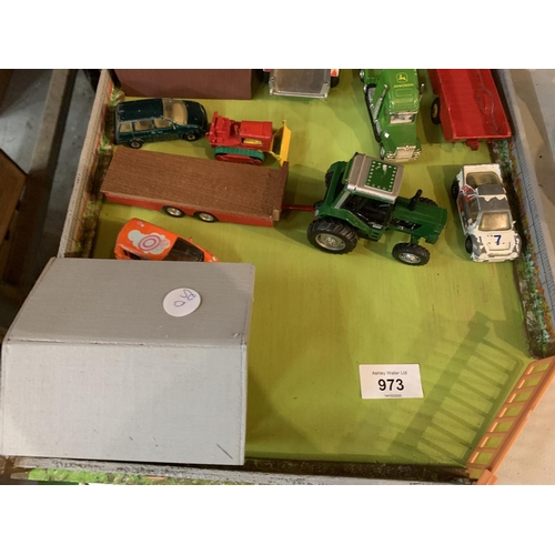 973 - A WOODEN FARM YARD LAYOUT WITH SHEDS AND DIECAST VEHICLES TO INCLUDE A JOHN DEERE LOW LOADER WAGON A... 