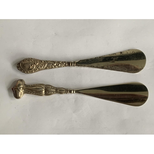 612 - TWO SHOEHORNS WITH HALLMARKED BIRMINGHAM SILVER HANDLES 1904 AND 1911