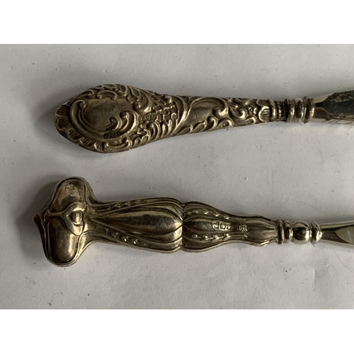 612 - TWO SHOEHORNS WITH HALLMARKED BIRMINGHAM SILVER HANDLES 1904 AND 1911