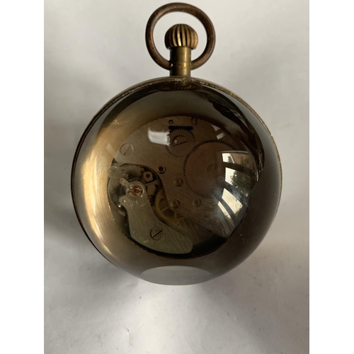 625 - A BRASS AND GLASS BUBBLE CLOCK IN WORKING ORDER