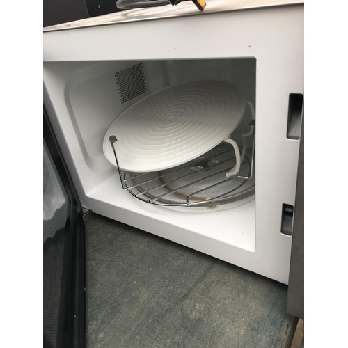 1724 - A SILVER MICROWAVE OVEN BELIEVED IN WORKING ORDER BUT NO WARRANTY