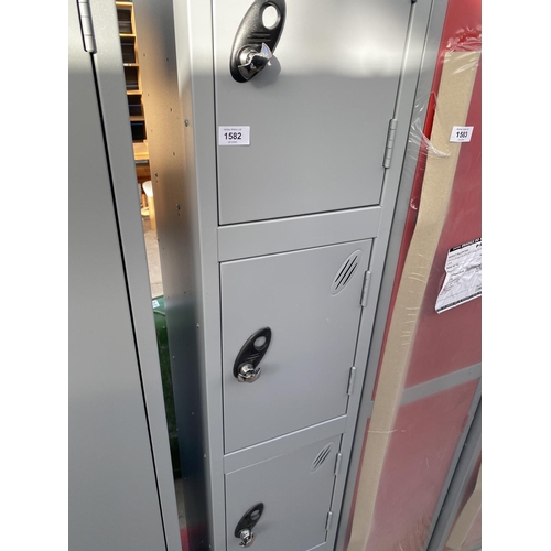 1582 - AN AS NEW GREY FOUR DOOR LOCKER