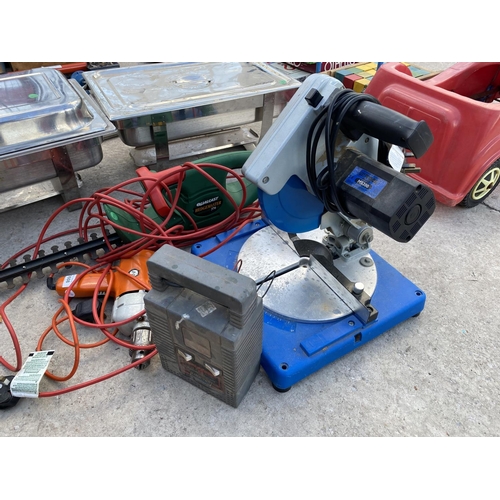 1608 - A COMPOUND MITRE SAW, HEDGE TRIMMER, DRILL AND BATTERY CHARGER